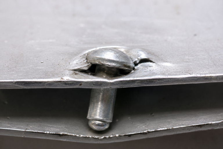 Loose blind rivet with a visible gap between the rivet head and sheet metal